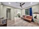 Bright living room features hardwood floors, a ceiling fan, and a cozy seating area at 1601 Eaton Dr, Las Vegas, NV 89102