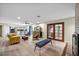 Open-concept living room with fireplace, modern furnishings, and view to kitchen and yard at 1601 Eaton Dr, Las Vegas, NV 89102