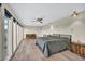 Bright main bedroom features a ceiling fan, wood floors, and great natural light at 1601 Eaton Dr, Las Vegas, NV 89102