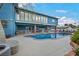 Backyard with pool, two-story home, manicured landscaping, and neutral patio at 1601 Eaton Dr, Las Vegas, NV 89102
