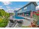 Backyard with pool, lounge chairs, lush landscaping, and two-story home at 1601 Eaton Dr, Las Vegas, NV 89102