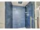 Close-up of modern shower featuring blue tiles and chrome fixtures in updated bathroom at 1601 Eaton Dr, Las Vegas, NV 89102