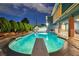 Swimming pool with diving board at dusk, surrounded by lush landscaping and the covered patio at 1601 Eaton Dr, Las Vegas, NV 89102