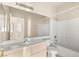 Bright bathroom features a wide mirror, white vanity, and a shower-tub combination at 199 Bailey Island Dr, Henderson, NV 89074