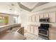 Well-lit kitchen features stainless steel appliances, light wood cabinets, and convenient breakfast bar at 199 Bailey Island Dr, Henderson, NV 89074