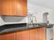 Granite countertop kitchen with stainless steel dishwasher and modern faucet at 200 W Sahara Ave # 1703, Las Vegas, NV 89102