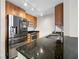 Close-up of kitchen with stainless appliances, granite countertops, and wood cabinetry at 200 W Sahara Ave # 1703, Las Vegas, NV 89102