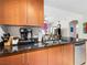Kitchen featuring wood cabinets and stainless steel appliances, with black granite countertops at 200 W Sahara Ave # 1703, Las Vegas, NV 89102