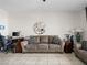Comfortable living room with a plush sofa, decorative mirror, and tile flooring at 200 W Sahara Ave # 1703, Las Vegas, NV 89102