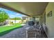 Inviting backyard featuring a covered patio, artificial turf, and lush landscaping at 205 Piedmont Alps St, Henderson, NV 89012