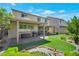Beautiful backyard featuring a covered patio, artificial turf, and decorative pond at 205 Piedmont Alps St, Henderson, NV 89012
