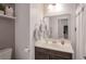 Cozy bathroom features vanity with towels, neutral decor, and bright mirror at 205 Piedmont Alps St, Henderson, NV 89012