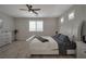 Comfortable bedroom featuring a ceiling fan, window shutters, and neutral tones at 205 Piedmont Alps St, Henderson, NV 89012