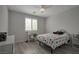 Clean bedroom features a workspace, ceiling fan, and large window at 205 Piedmont Alps St, Henderson, NV 89012