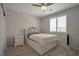 Bright bedroom with a white bed featuring storage drawers, accompanied by a ceiling fan and window at 205 Piedmont Alps St, Henderson, NV 89012
