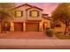 Charming two-story home featuring a three-car garage and a well-manicured front yard under a beautiful sunset at 205 Piedmont Alps St, Henderson, NV 89012