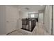 Hallway with a dark wood railing and doors leading to other rooms in the house at 205 Piedmont Alps St, Henderson, NV 89012