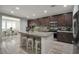 Well-equipped kitchen with a center island, stainless appliances, and dark wood cabinets at 205 Piedmont Alps St, Henderson, NV 89012
