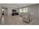 Bright living room with a white leather sofa, fireplace, and a ceiling fan at 205 Piedmont Alps St, Henderson, NV 89012