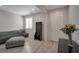 Inviting living room with a comfortable gray sofa, stylish accent furniture, and a bright window at 205 Piedmont Alps St, Henderson, NV 89012