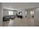 Open living area with wood floors, a sectional sofa, a TV, and easy access to the bedroom at 205 Piedmont Alps St, Henderson, NV 89012