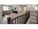 Upstairs living area with modern gray sofa, television, and hardwood floors at 205 Piedmont Alps St, Henderson, NV 89012