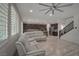 Spacious living area showcases stylish wood floors, white sectional sofa, and an open-concept kitchen at 205 Piedmont Alps St, Henderson, NV 89012