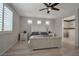 Bedroom with a white wooden bed frame, ceiling fan, and en-suite bathroom at 205 Piedmont Alps St, Henderson, NV 89012