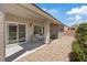 Covered back patio features seating area and sliding glass door access to the home at 2108 Willow Wren Dr, North Las Vegas, NV 89084