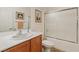 Bright bathroom featuring a tub with sliding glass doors, a toilet, and a vanity with a white countertop at 2108 Willow Wren Dr, North Las Vegas, NV 89084