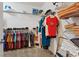 Well-organized walk-in closet featuring shelving, hanging rods, and ample storage space for clothes and accessories at 2108 Willow Wren Dr, North Las Vegas, NV 89084