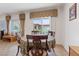 Charming dining area featuring tiled floors, neutral decor, and a view of the outdoor scenery at 2108 Willow Wren Dr, North Las Vegas, NV 89084