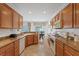 Spacious kitchen with granite counters, oak cabinets, and a view into the dining area at 2108 Willow Wren Dr, North Las Vegas, NV 89084