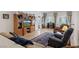 Open-concept living area featuring tile flooring, a built-in entertainment center, and comfortable furniture at 2108 Willow Wren Dr, North Las Vegas, NV 89084