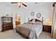 Serene carpeted bedroom features a decorative dresser, two nightstands, and traditional wooden furniture at 2108 Willow Wren Dr, North Las Vegas, NV 89084
