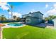Backyard featuring a pool, grassy area, and home exterior at 2180 Palora Ave, Las Vegas, NV 89169