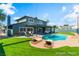 Backyard featuring a pool, grassy area, and outdoor seating at 2180 Palora Ave, Las Vegas, NV 89169