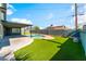 An inviting backyard with a sparkling pool, manicured lawn, and a covered patio, perfect for outdoor relaxation at 2180 Palora Ave, Las Vegas, NV 89169