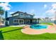 Large backyard featuring a pool, grassy area, and covered patio at 2180 Palora Ave, Las Vegas, NV 89169