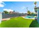 Backyard featuring a pool, grassy area, and privacy fence at 2180 Palora Ave, Las Vegas, NV 89169