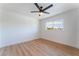 Bedroom featuring wood floors, ceiling fan, and large window at 2180 Palora Ave, Las Vegas, NV 89169