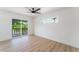 Bright bedroom featuring wood floors, ceiling fan, and sliding door to balcony at 2180 Palora Ave, Las Vegas, NV 89169