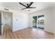 Bedroom with wood floors, ceiling fan, and sliding door to balcony at 2180 Palora Ave, Las Vegas, NV 89169