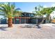 Two-story home exterior featuring a balcony, two-car garage, and desert landscaping at 2180 Palora Ave, Las Vegas, NV 89169