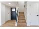 Bright hallway with hardwood floors and a staircase leading to the second story at 2180 Palora Ave, Las Vegas, NV 89169