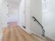 Bright hallway featuring wood floors, staircase, and modern lighting at 2180 Palora Ave, Las Vegas, NV 89169