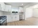 Updated kitchen features white cabinets, stainless steel appliances, and granite countertops at 2180 Palora Ave, Las Vegas, NV 89169