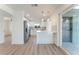 Open concept kitchen with stainless steel appliances, modern white cabinetry, and breakfast bar at 2180 Palora Ave, Las Vegas, NV 89169