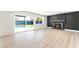 Bright living room featuring hardwood floors, a fireplace, and large windows showcasing the backyard pool at 2180 Palora Ave, Las Vegas, NV 89169