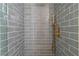 Close up of tiled shower with glass enclosure and gold hardware at 2180 Palora Ave, Las Vegas, NV 89169